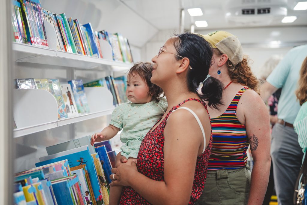 Staff welcome patrons into the bookmobile at the unveiling ceremony.