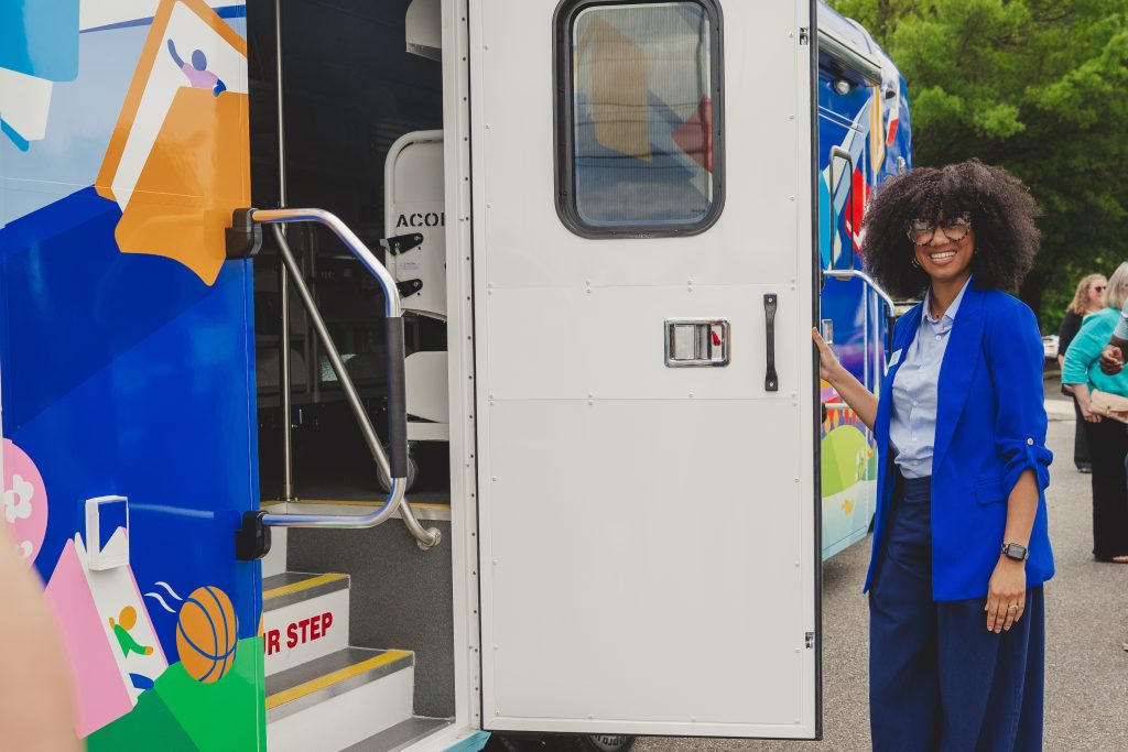 Staff welcome patrons into the bookmobile at the unveiling ceremony.