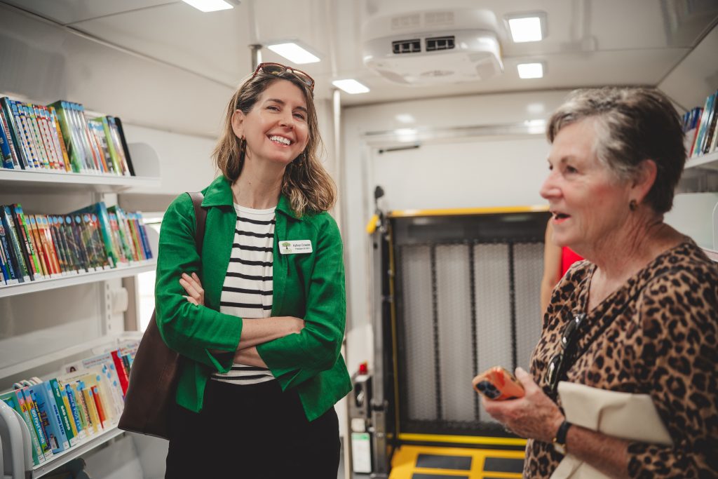 Staff welcome patrons into the bookmobile at the unveiling ceremony.