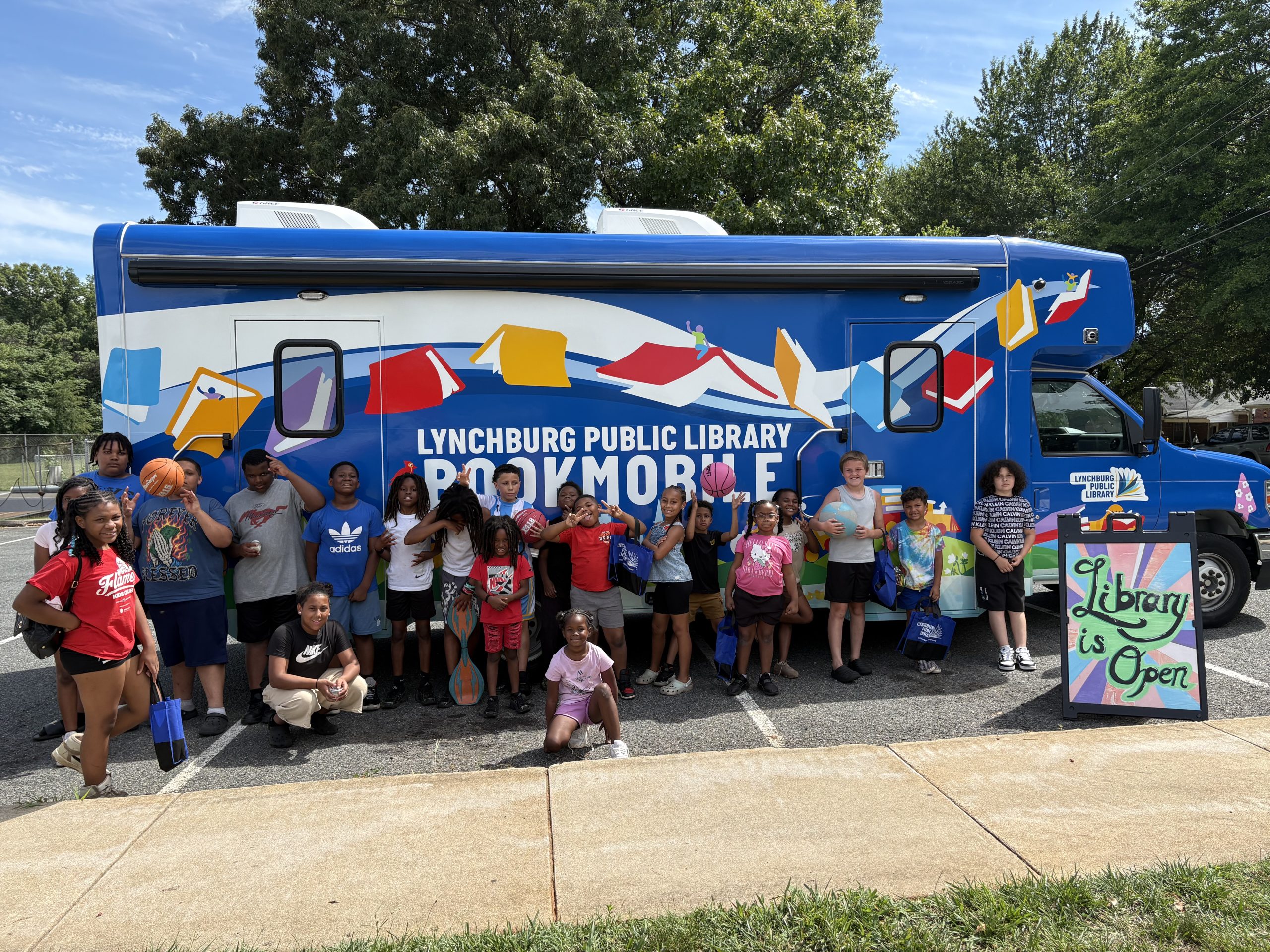 children pose with the bookmobile